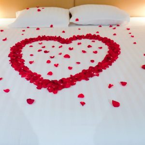 Wedding bed topped with rose petals, Thai style wedding